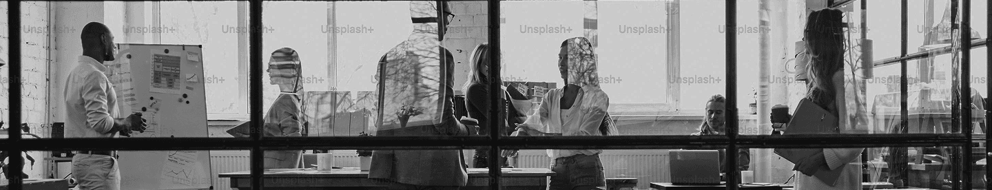 Office workspace scene viewed through window frame